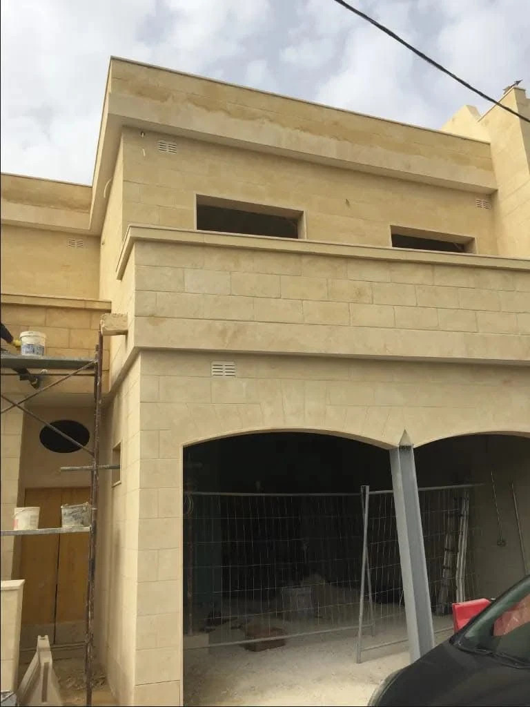 Limestone residence with arched garage
