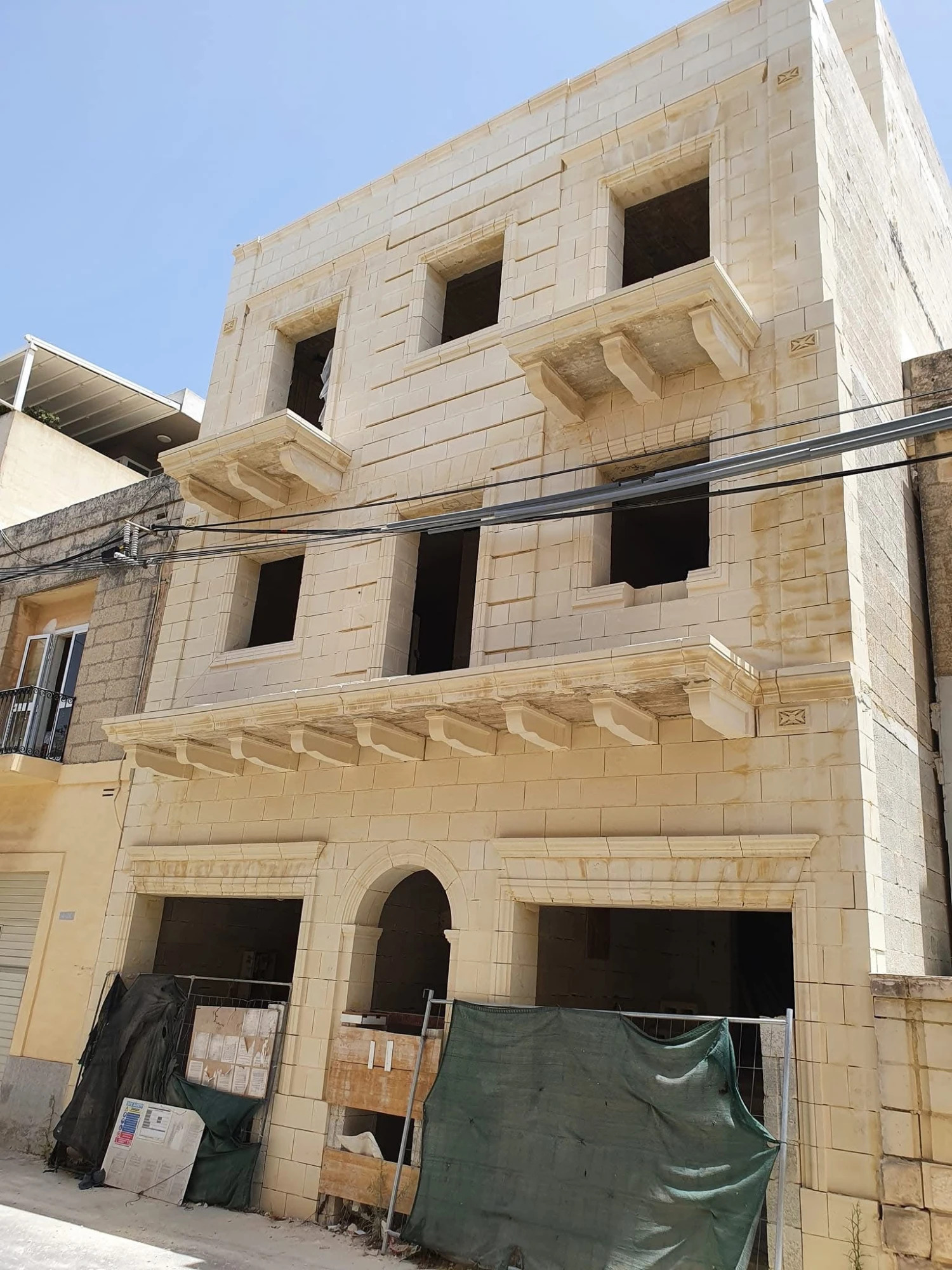 Ornate limestone building with decorative cornices